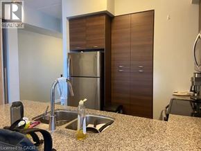 Waterloo condo for rent - A kitchen with a sink, a refrigerator, and a countertop.