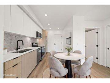 Langley apartment for rent - A modern kitchen with a dining table set for four.