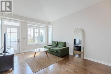 Ottawa condo for rent - A living room with a green couch and a television.