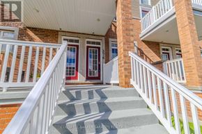 Ottawa condo for rent - A red door with a white railing and steps leading up to it.