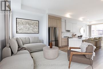 Toronto (Humewood-Cedarvale) townhouse for rent - A modern living room with a grey sofa and a wooden coffee table.