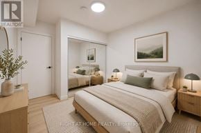 Toronto (Casa Loma) multi-family for rent - A bedroom with a large bed and a mirror on the wall.
