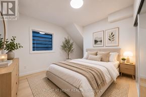 Toronto (Casa Loma) multi-family for rent - A bedroom with a bed, nightstand, and a plant.
