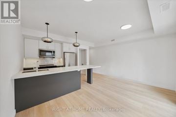 Toronto (Casa Loma) multi-family for rent - A modern kitchen with a white countertop and a microwave above it.