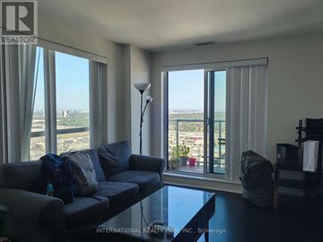 Toronto (Bendale) condo for rent - A living room with a grey couch and a view of the outside through the windows.