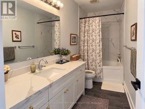 Oshawa (O'neill) multi-family for rent - A bathroom with a marble shower and a floral shower curtain.