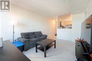 Toronto (Woburn) condo for rent - A living room with a grey couch and a black coffee table.