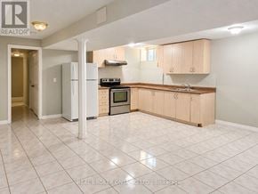 Vaughan (Vellore Village) apartment for rent - A kitchen with white appliances and wooden cabinets.