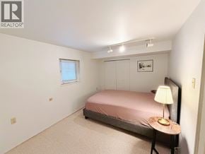 Vancouver apartment for rent - A bedroom with a bed, a lamp, and a picture on the wall.