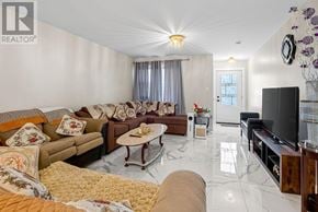 Azilda apartment for rent - A living room with a brown couch, a coffee table, and a flat screen TV.