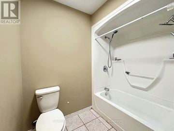 Ottawa apartment for rent - A white toilet sits next to a white bathtub in a bathroom.