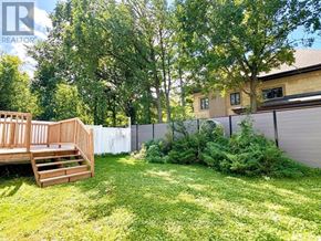 Ottawa apartment for rent - A backyard with a wooden deck and a fence.