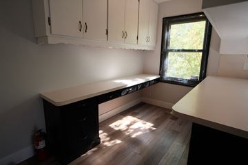Minneapolis apartment for rent - A kitchen with white cabinets and a black counter.
