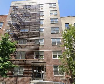 New York apartment for rent - A tall brick building with a fire escape on the side.