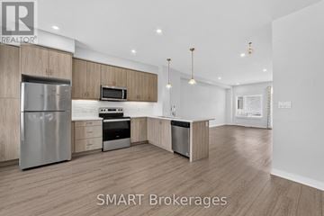 Cambridge townhouse for rent - A modern kitchen with wooden cabinets and stainless steel appliances.