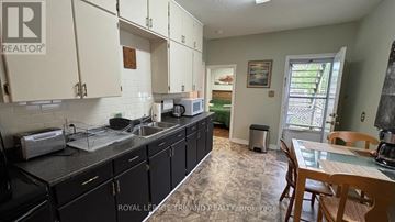 Central Elgin (Port Stanley) duplex for rent - A kitchen with black cabinets and a sink.