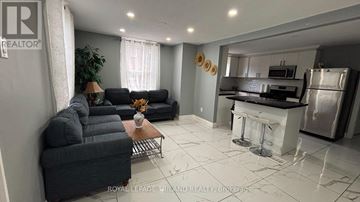 Central Elgin (Port Stanley) duplex for rent - A living room with a black couch and a coffee table.