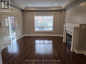 Brampton (Credit Valley) apartment for rent - A spacious living room with wood flooring and a fireplace.