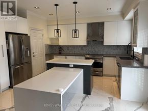Brampton (Credit Valley) apartment for rent - A modern kitchen with a large island in the center.