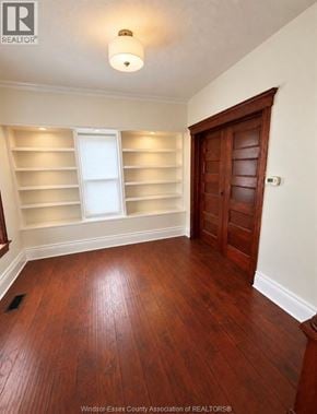 Windsor apartment for rent - A room with wooden floors and a window with shutters.
