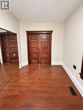 Windsor apartment for rent - A room with wooden floors and a wooden door.