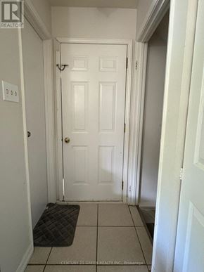 London South (South X) apartment for rent - A hallway with a door and a mat on the floor.