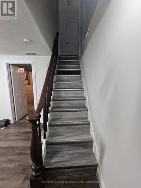 London South (South X) apartment for rent - A staircase with a wooden handrail and steps leading to a doorway.