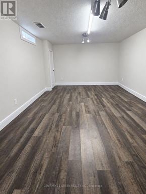 London South (South X) apartment for rent - A room with wooden flooring and a window on the wall.