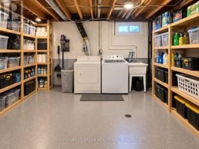 London South (South X) apartment for rent - A laundry room with a washer and dryer, surrounded by shelves with supplies.
