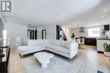 Toronto (Willowdale West) apartment for rent - A modern living room with a white sofa and a grey rug.