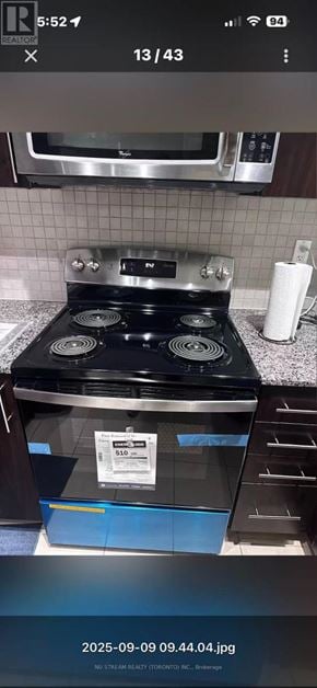Markham (Unionville) condo for rent - A black stove top oven with a blue drawer in front of it.