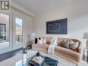 Whitchurch-Stouffville (Ballantrae) apartment for rent - A living room with a couch, a coffee table, and a painting on the wall.