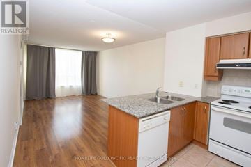 Vaughan (Beverley Glen) condo for rent - A kitchen with wooden cabinets and a granite countertop.