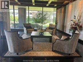 Windsor condo for rent - A room with a table and chairs and a sign that says REALTOR.