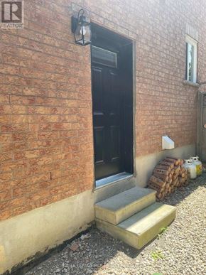 Caledon (Bolton North) apartment for rent - A brick wall with a door and a window.