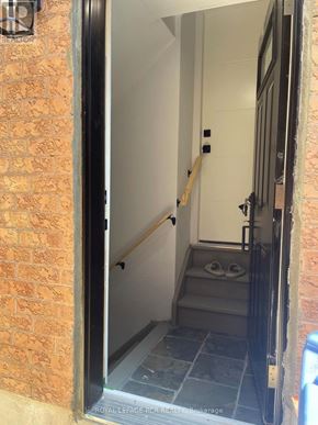 Caledon (Bolton North) apartment for rent - A doorway with a brick wall on the left and a tiled floor.