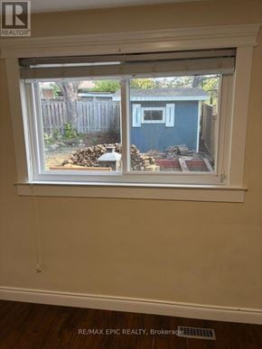 Mississauga (Erindale) apartment for rent - A window with a view of a blue shed and a wooden fence.