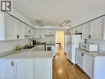 Cambridge apartment for rent - A kitchen with white cabinets and appliances.