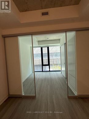 Toronto (Kensington-Chinatown) condo for rent - A room with a sliding door leading to a balcony.