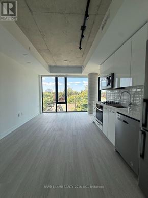 Toronto (Kensington-Chinatown) condo for rent - A modern kitchen with white cabinets and stainless steel appliances.