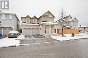 Ajax (Central East) apartment for rent - A real estate listing photo of a house with a car parked in front.