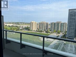 Richmond Hill (Langstaff) condo for rent - A view from a balcony overlooking a cityscape with buildings and a parking lot.