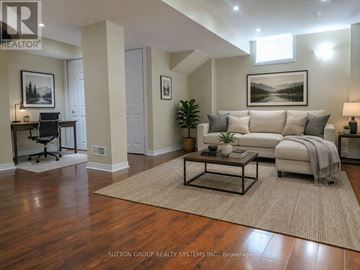 Brampton (Fletcher's Meadow) apartment for rent - A well-lit living room with a couch, coffee table, and a painting on the wall.