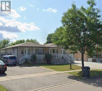 Mississauga (Malton) apartment for rent - A house with a car parked in front of it.