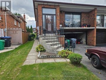 Mississauga (Rathwood) apartment for rent - A house with a red brick exterior and a balcony is for sale.