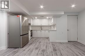Mississauga (Churchill Meadows) apartment for rent - A kitchen with white cabinets and a stainless steel refrigerator.