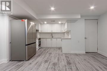 Mississauga (Churchill Meadows) apartment for rent - A kitchen with white cabinets and a stainless steel refrigerator.