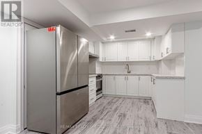 Mississauga (Churchill Meadows) apartment for rent - A kitchen with a stainless steel refrigerator and white cabinets.