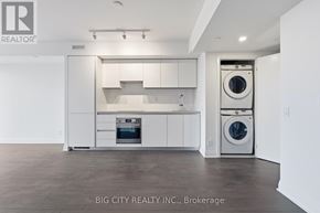 Toronto (Thorncliffe Park) condo for rent - A white kitchen with a washer and dryer built in.