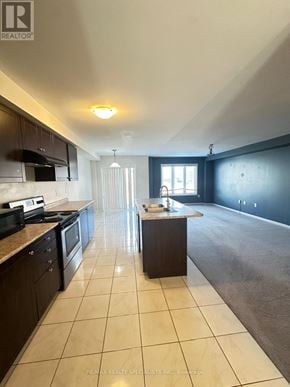 Brantford townhouse for rent - A kitchen with dark wood cabinets and a white countertop.